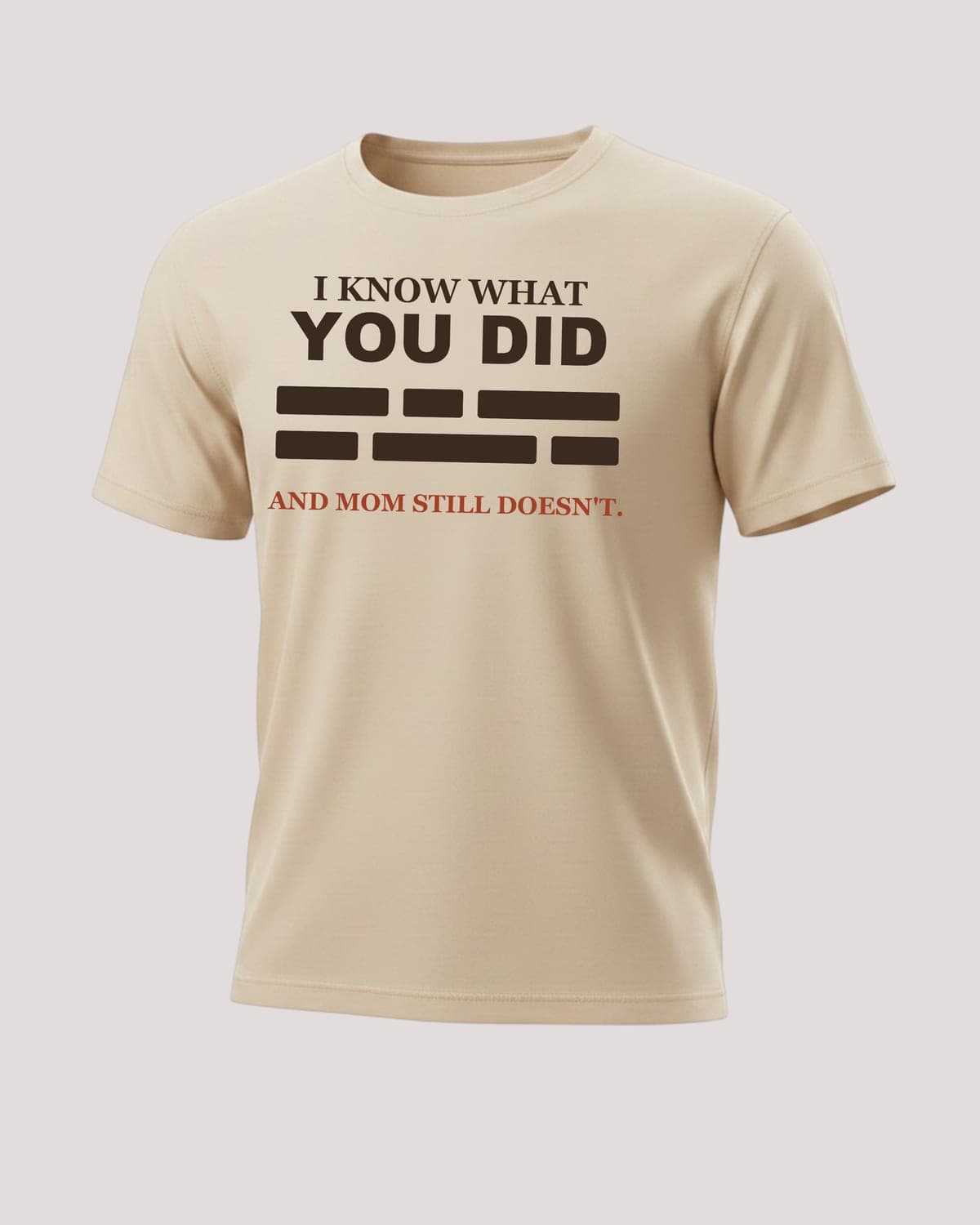 Redacted Tee in Beige — "Mom Still Doesn't Know" print, flat